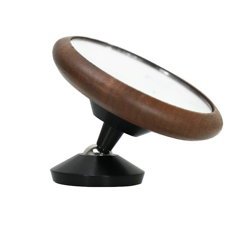 Round mirror with wooden frame and black base on a white background