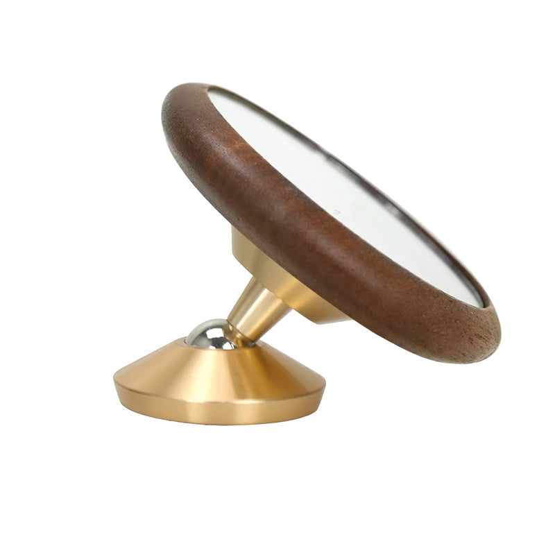 Round object with wooden top and gold base on a white background