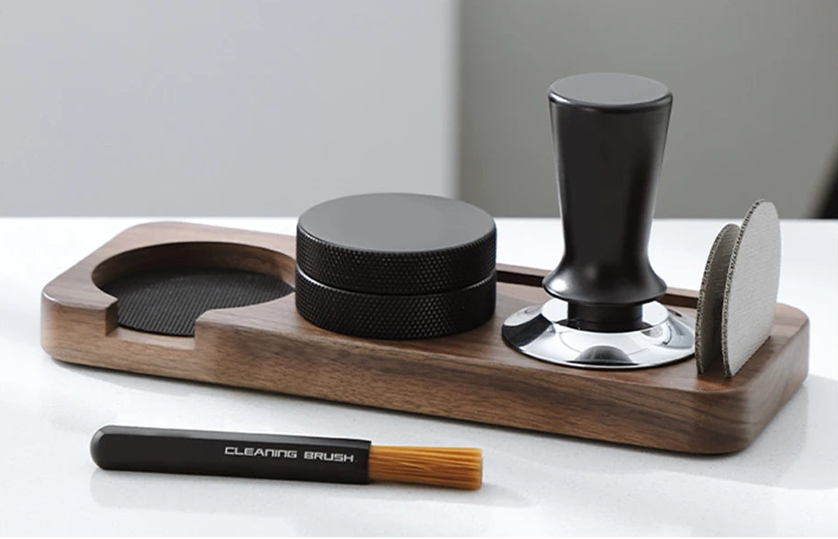 Multifunctional coffee holder with wooden base, black components, and cleaning brush on a white surface.